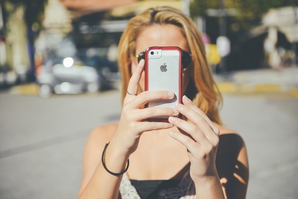 woman taking picture with smartphone