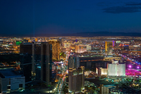 Large casino hotel at night in Las Vegas, illustrating the strict 21+ age policy enforced at Strip properties