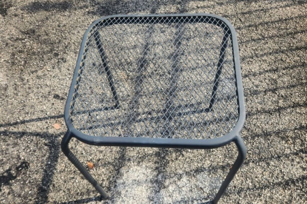 Small metal outdoor side table with a mesh top that I picked up free from a curb and resold the same afternoon for $15.
